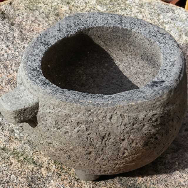 A traditional molcajete, made from volcanic stone, adds a unique flavor to culinary creations.