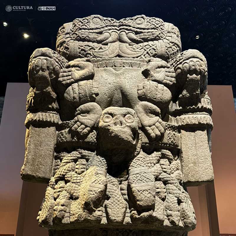 A close-up of the Coatlicue sculpture, showing the goddess's face and the intricate details of her necklace.