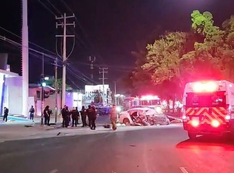 Emergency responders working on a street with a damaged car.