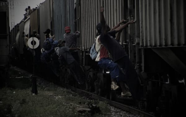 Migrants train surfing in Mexico at night.