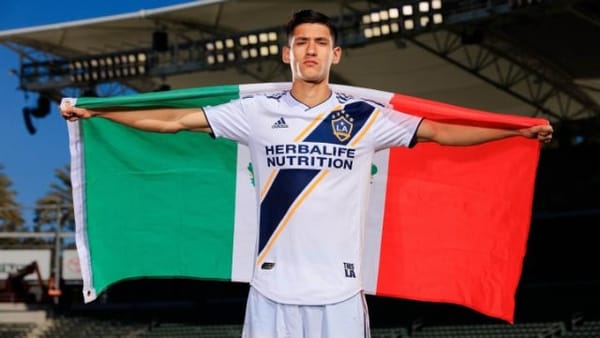 Uriel Antuna with a flag.