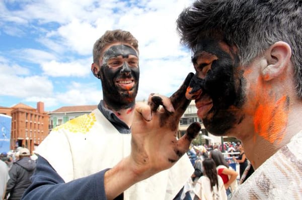 Two men painting each other's faces at the Black and White Carnival in Pasto, southern Colombia.