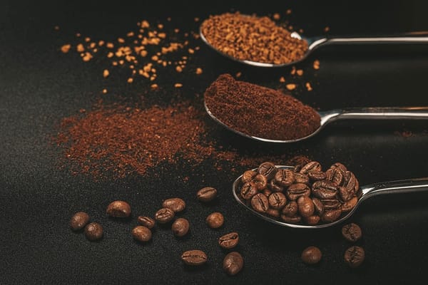 Three spoons of coffee with Soluble coffee, coffee beans and ground coffee.