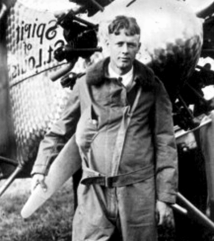 Charles Lindbergh leaning on the propeller of the Spirit of St. Louis, portrait.