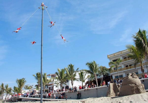 The Papantla Flyers spin bravely and dizzyingly around the pole until they reach the ground.