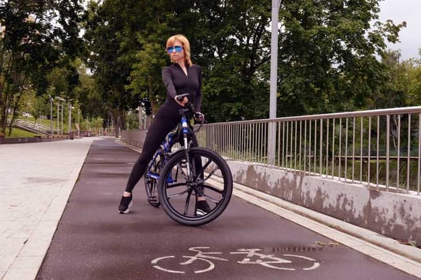 Cyclist enjoying the health benefits of urban commuting amidst the cityscape.