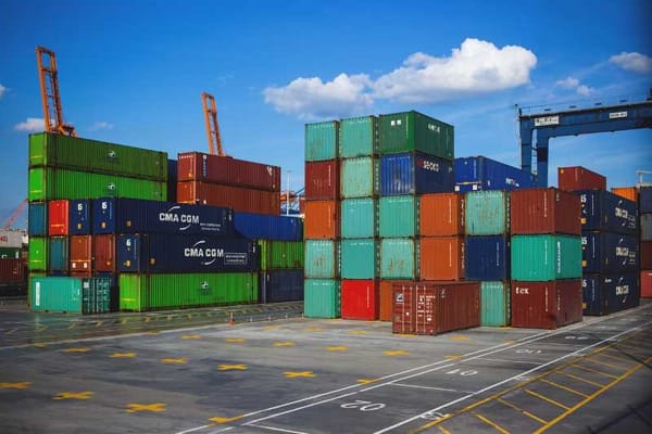 Containers stacked high at a port as demand surges, driving up prices in the country's booming industrial sector.