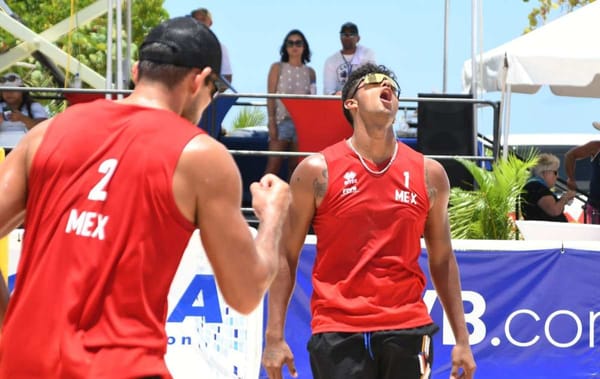 Mexican beach volleyball players in action during a competitive match.