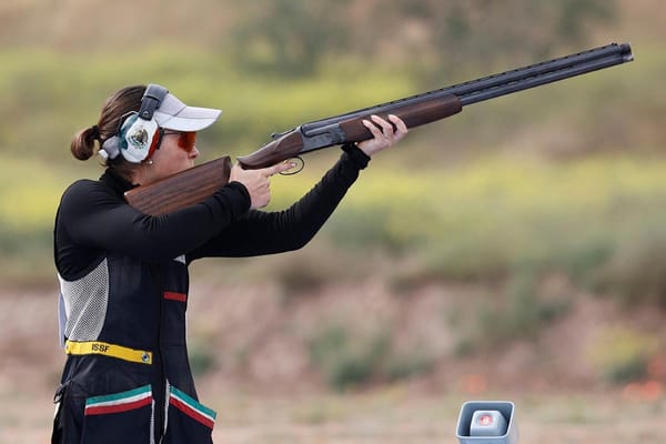 Mexican shooter Gabriela Rodríguez Garza taking aim, facial expression showing intense focus.