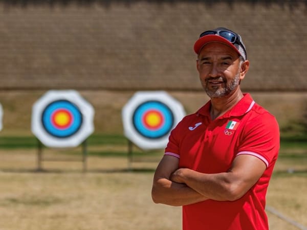 Coach Miguel Ángel Flores Castañeda observes the archery team selections with a focused expression.