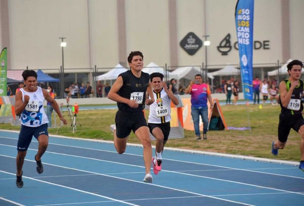 Sprinter lunges forward to break the finish line tape, winning the race.