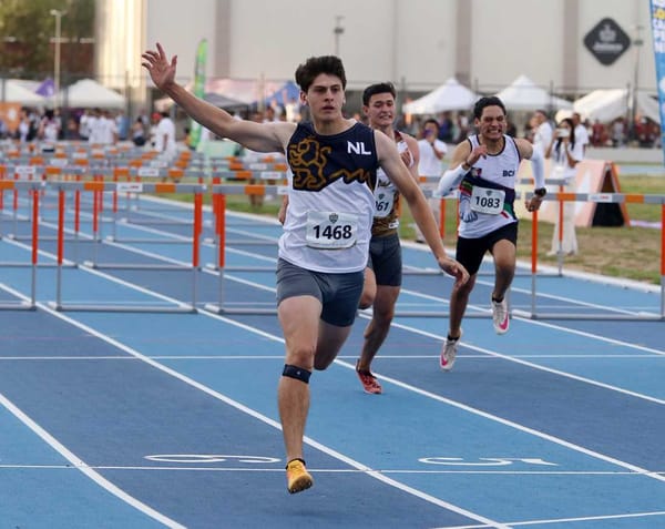 José Eduardo Aguado Peña crossing the finish line with a time of 13.77 seconds in the 110-meter hurdles.