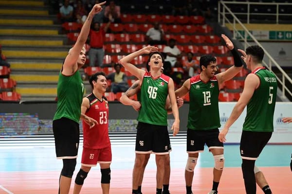 A photo of Mexican volleyball players celebrating a point with their arms raised.
