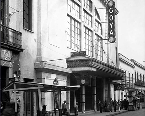 A black and white photo of the Goya Cinema, a grand movie theater with ornate architecture.