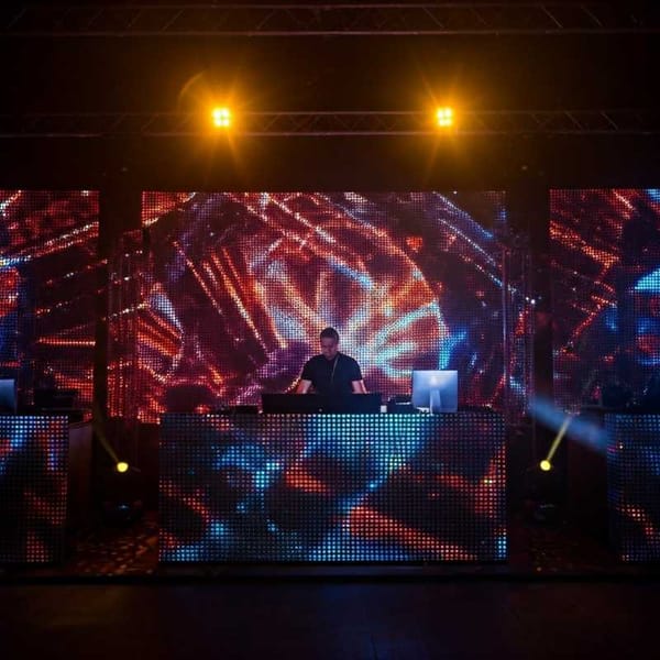 A DJ booth at Coco Bongo as the DJ mixes tracks.