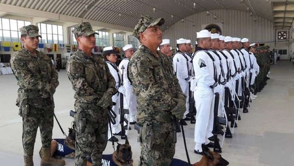 A photo of a group of police officers and Navy marines standing together in Cancun.