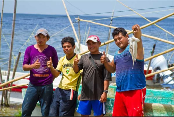 A Mexican fisherman holding a large octopus.