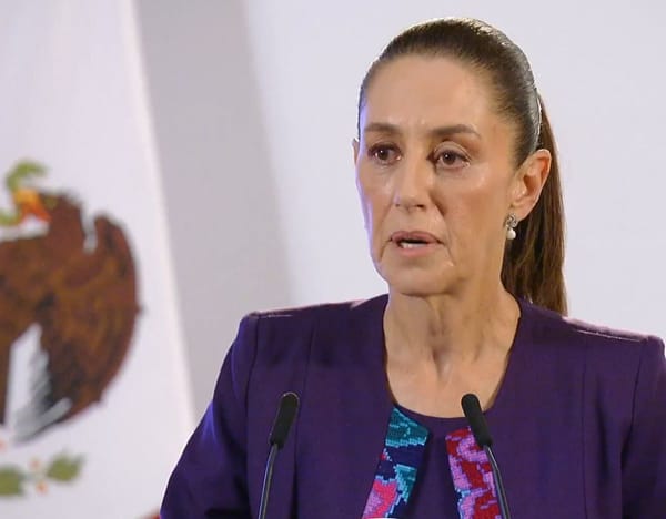 President Claudia Sheinbaum speaking at a podium during a press conference.