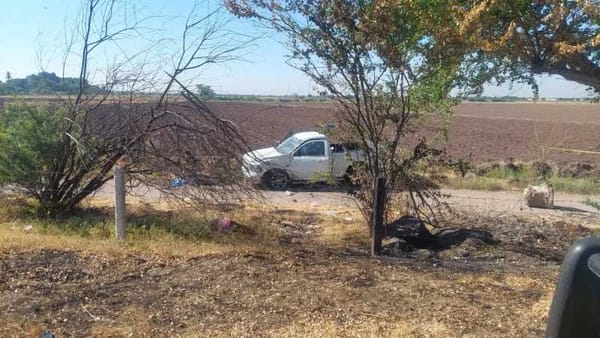 A bullet-riddled white Dodge Hemi RAM pickup truck on the side of a highway near San Blas, Navolato, Mexico.