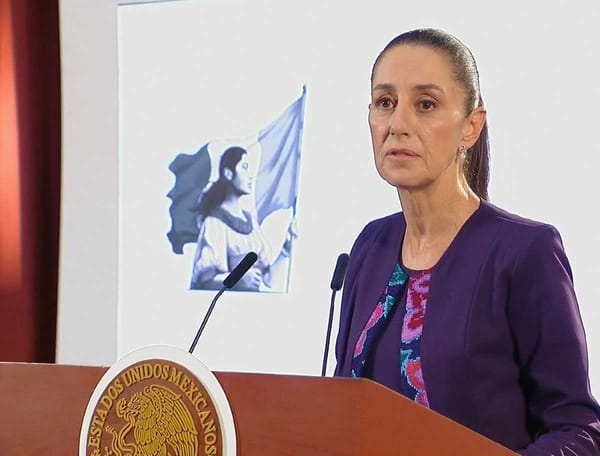 President Claudia Sheinbaum speaking at a conference, with a determined expression.