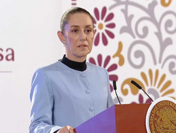 President Claudia Sheinbaum speaking at a podium.