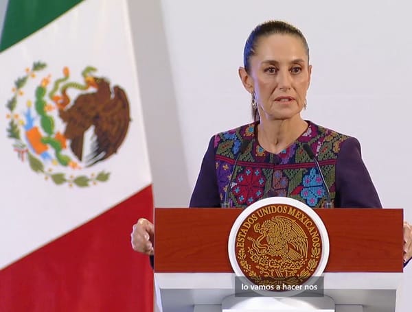 President Claudia Sheinbaum speaking at a podium during a press conference.