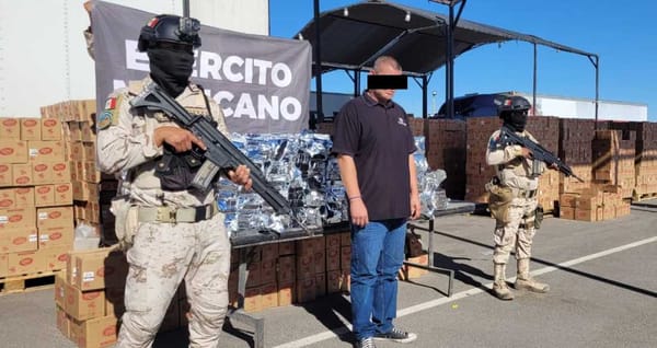 Mexican Army officers standing next to a seized drug shipment.