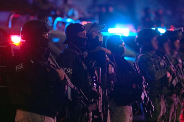 Mexican law enforcement officials in tactical gear conducting search operations inside taxi union facilities.