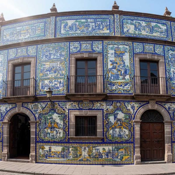 The colorful facade of a building adorned with intricate Talavera tiles in Puebla, Mexico.